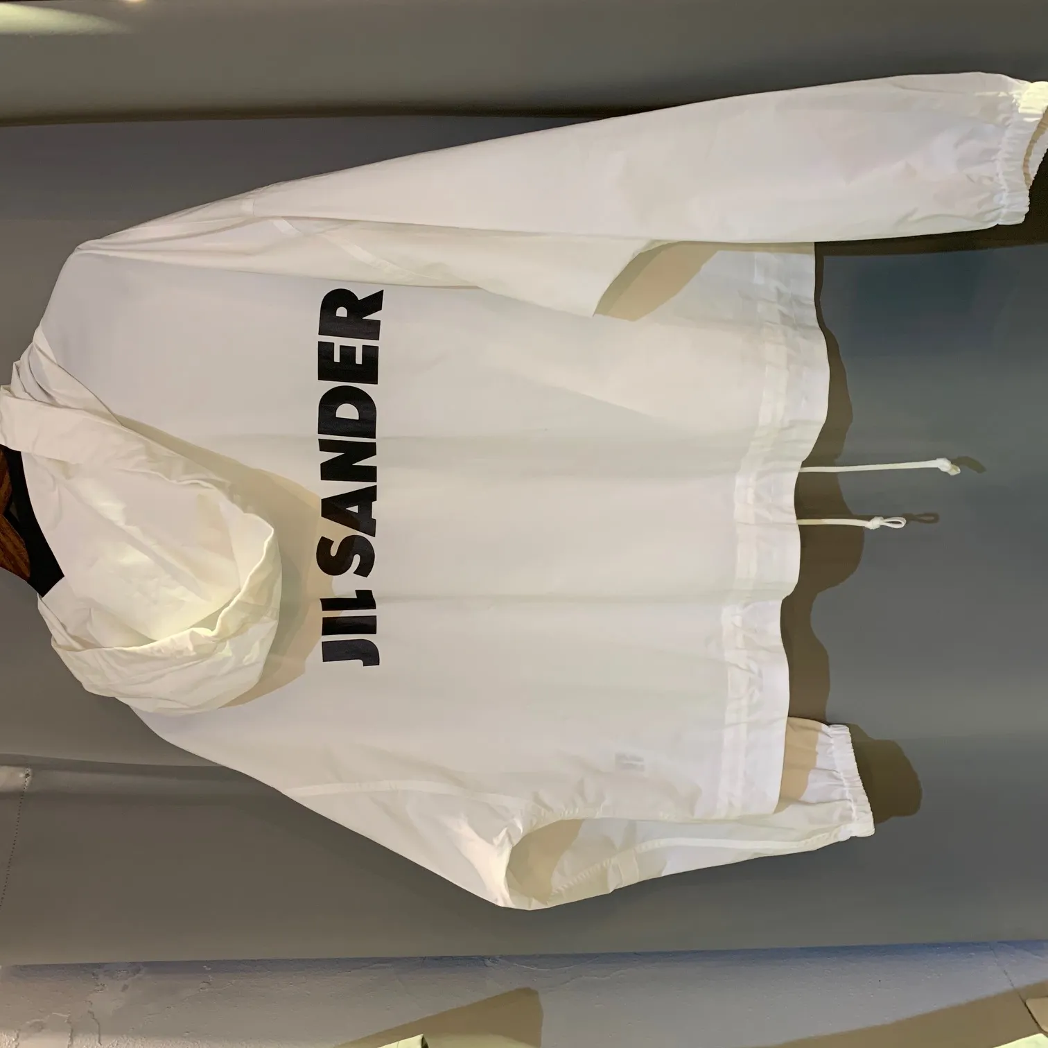 JIL SANDER JIL SANDER Back Logo Print Concealed Windbreaker